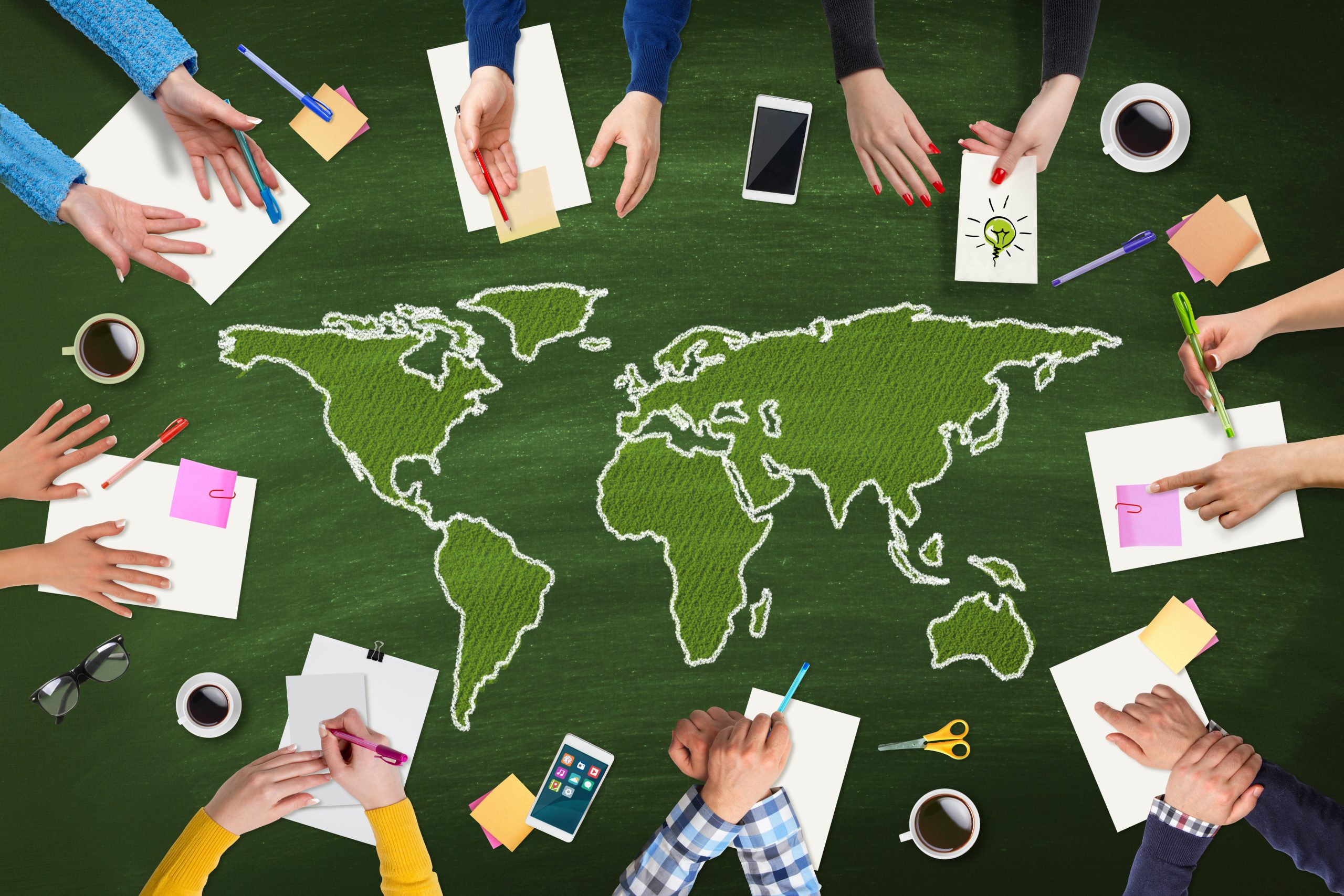 Business people meeting with Green World map on table